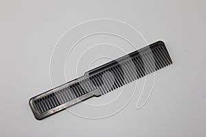 The black comb of the barber Placed on a gray background
