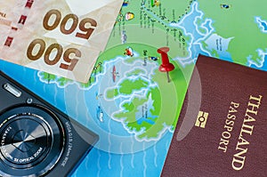 Black compact camera and map and money and passport