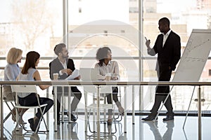 Black company owner make presentation to workers during briefing