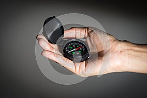 Black compass in woman hand