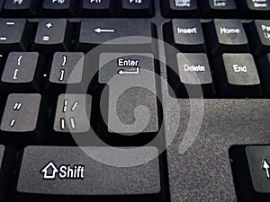 Black and computer keyboard close-up. Overlooking the enter button