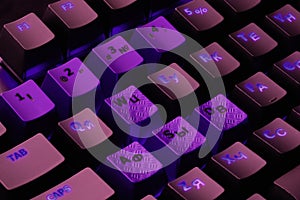 Black computer keyboard with purple keys, latin and cyrillics