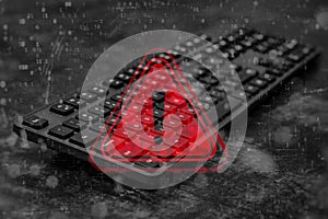 Black computer keyboard with a red warning triangle and exclamation mark overlay with digital binary code data. Concept