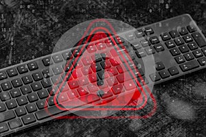 Black computer keyboard with a red warning triangle and exclamation mark overlay with digital binary code data. Concept
