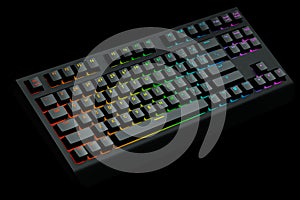 Black computer keyboard with rgb colors isolated on black background.