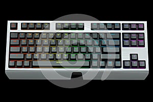 Black computer keyboard with rgb colors isolated on black background.