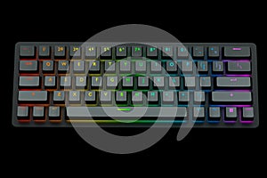 Black computer keyboard with rgb colors isolated on black background.