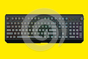 Black computer keyboard with rgb colors isolated on yellow background.