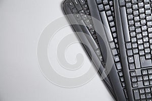 Black computer keyboards on grey background