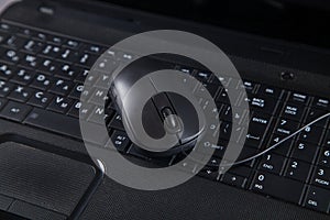 Black computer and mouse on gray table with empty screen