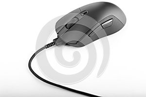 Black computer mouse with a wire on a white background