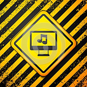 Black Computer with music note symbol on screen icon isolated on yellow background. Warning sign. Vector