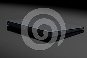 Black computer trackpad or wireless touch pad isolated on black background photo