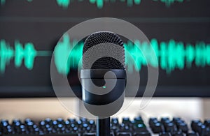 Black condenser microphone, blur turquoise waveform background