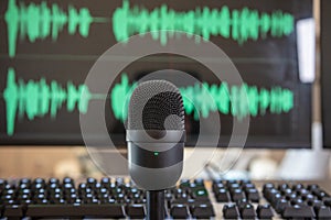 Black condenser microphone, mic blur turquoise waveform background