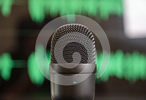Black condenser microphone, mike blur green waveform background