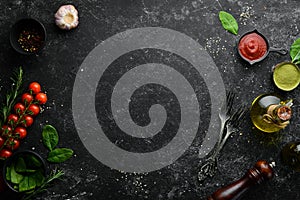 Black cooking background. Vegetables and spices on the table. Top view.