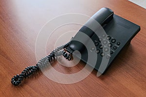 Black corded telephone with buttons