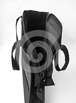 A black cordura bag with an open zipper on an isolated white background photo