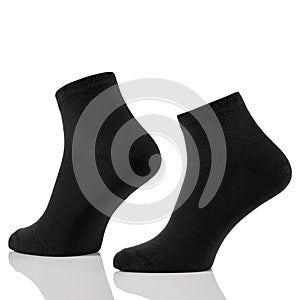 Black cotton short sock on invisible foots isolated on white background.