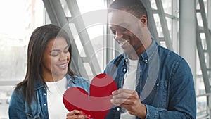 Black Couple Connecting Heart Halves, Meeting In Airport After Separation