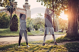Black couple doing exercise outdoors