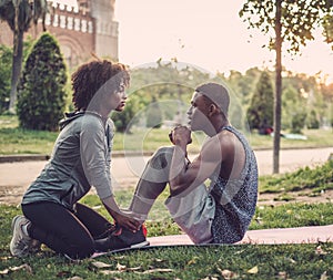 Black couple doing exercise outdoors