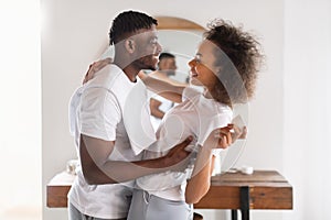 Black Couple Embracing And Flirting Making Morning Routine In Bathroom