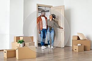 Black Couple Entering New Home Together, Hugging Moving House