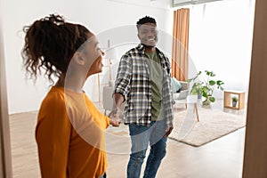 Black Couple Entering Their House Holding Hands Standing Indoors