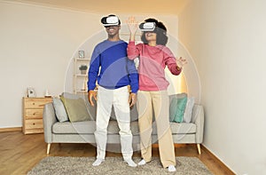 black couple fully immersed in virtual reality game at home