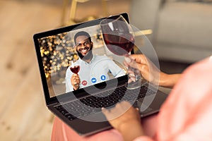 Black couple having online date, drinking red wine