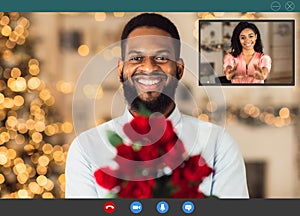 Black couple having romantic online date, celebrating anniversary