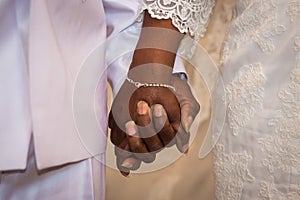 Black couple holding hands during marriage
