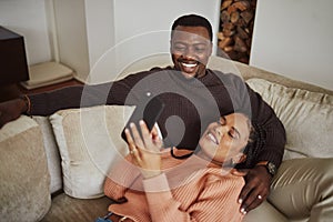 Black couple, phone and funny social media post while together on living room couch with home wifi for internet. Man and