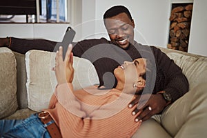 Black couple, phone and home wifi for internet connection while together on living room couch with love. Young man and