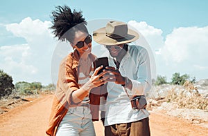 Black couple with phone, travel and adventure, happy outdoors in outback Australia during summer vacation. Romantic