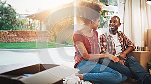 Black couple, real estate and happy on floor of new house with bonding, support and break or relax from moving. People