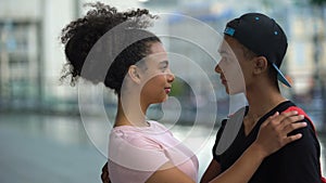 Black couple of teenagers hugging during outdoor date, love connection affection