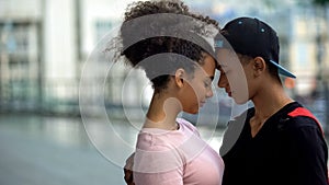 Black couple of teenagers hugging during outdoor date, love connection affection