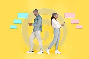 Black Couple Using Phones On Yellow Background With Message Icons