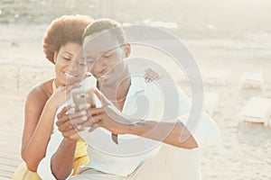 Black couple young man and woman enjoy together connection technology using mobile phone and app. Happy modern people writing on