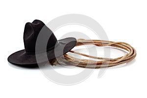 Black cowboy hat and lasso on white