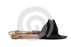Black cowboy hat and lasso on white