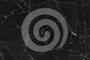 Black cracked glass texture background. Crack on the glass. Broken screen. Broken dark phone.  White cracks in glass