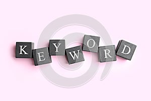 Black cubes with word KEYWORD on pink background
