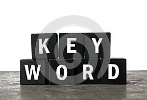 Black cubes with word KEYWORD on table