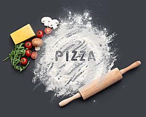 Black culinary background with pizza ingredients. Concept for a pizza recipe.