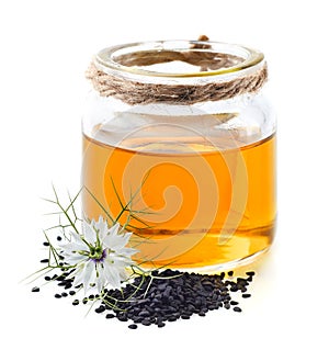 Black cumin oil with flower and seeds