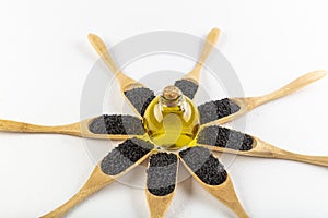 Black cumin oil pill. Black cumin or black caraway spicy seeds in wood spoon isolated on white background. Nigella sativa also